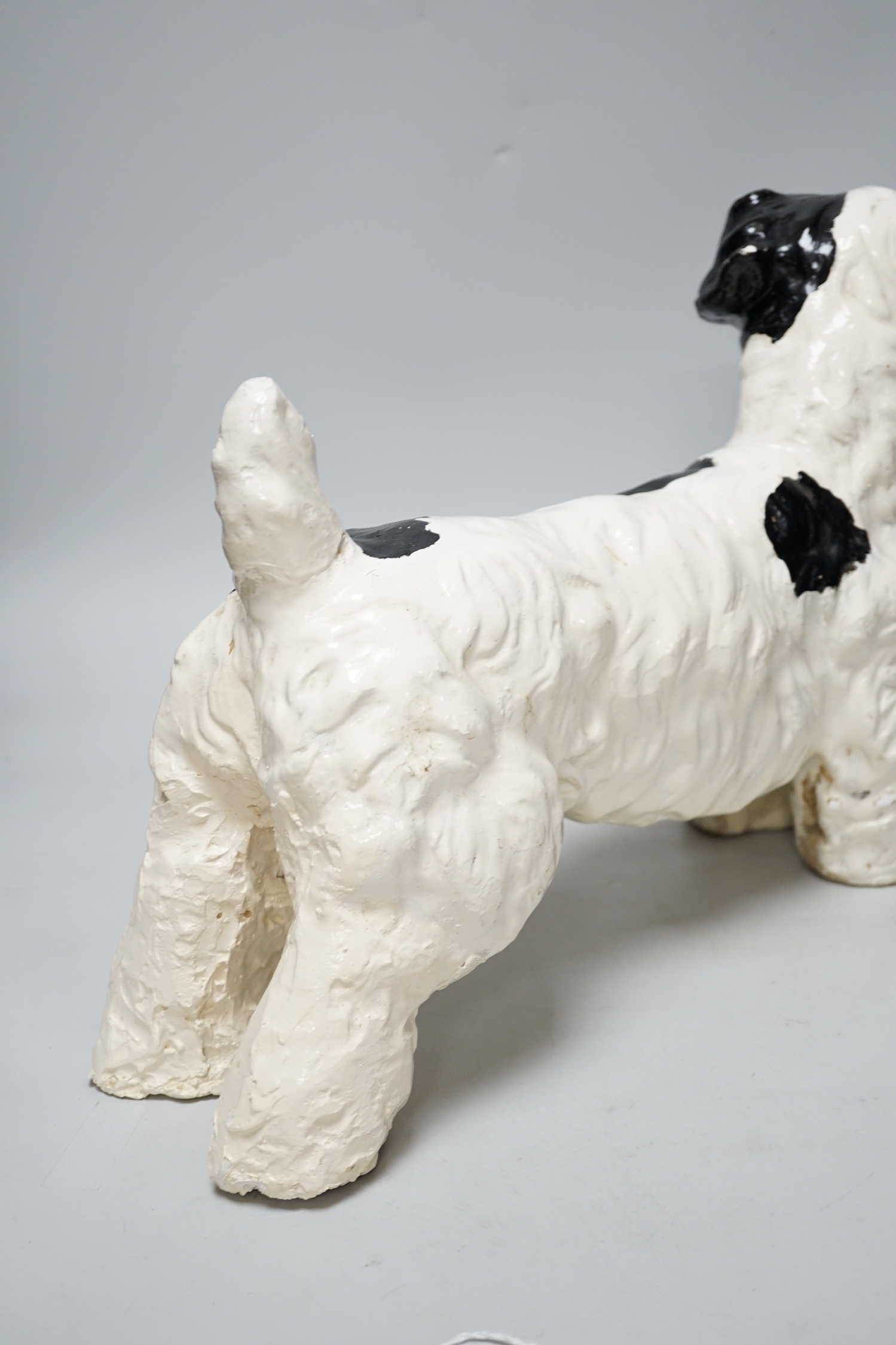 A painted plaster model of a terrier dog, 28cm high, 41cm long